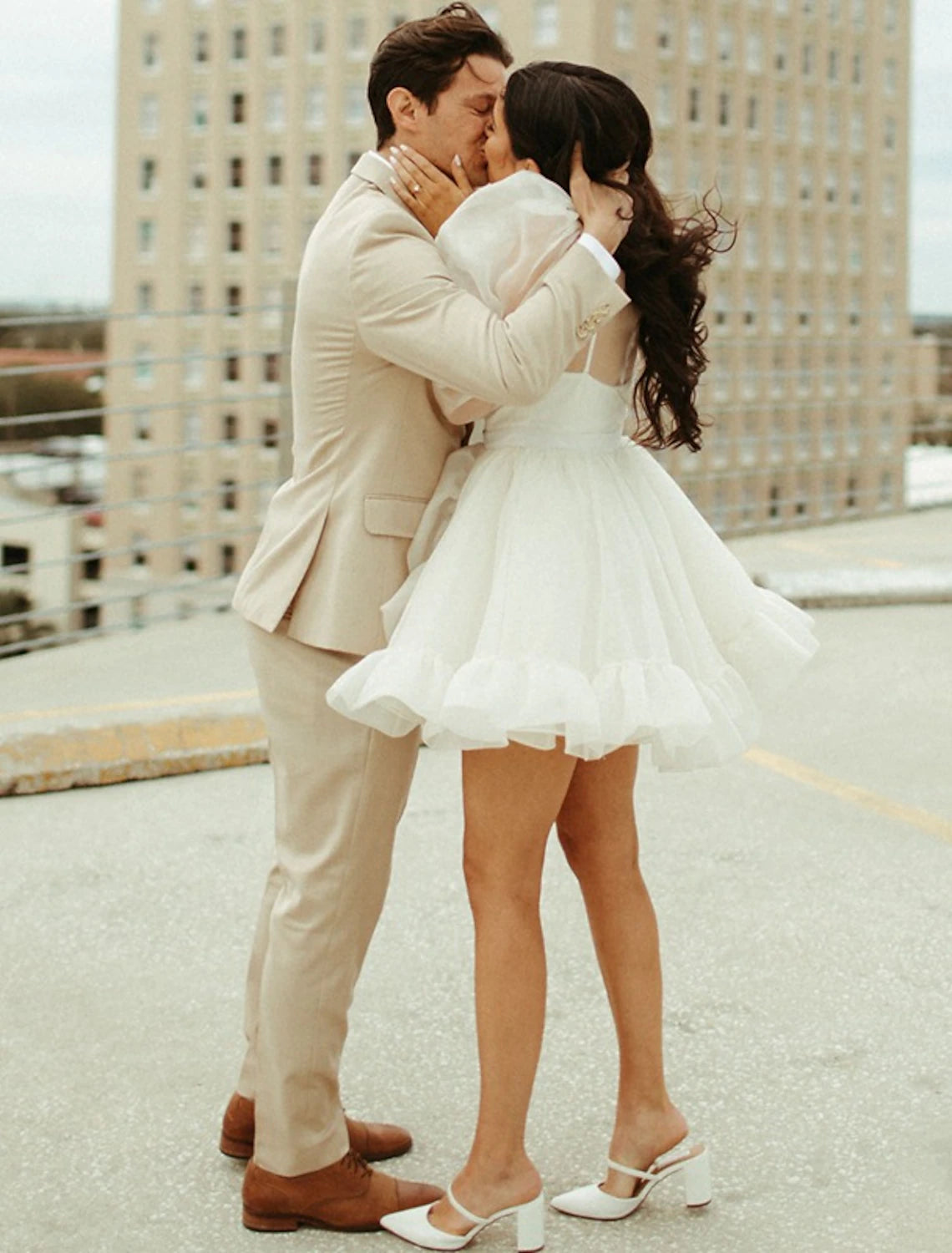 Side view of the A-line high neck long sleeve organza mini wedding reception dress.