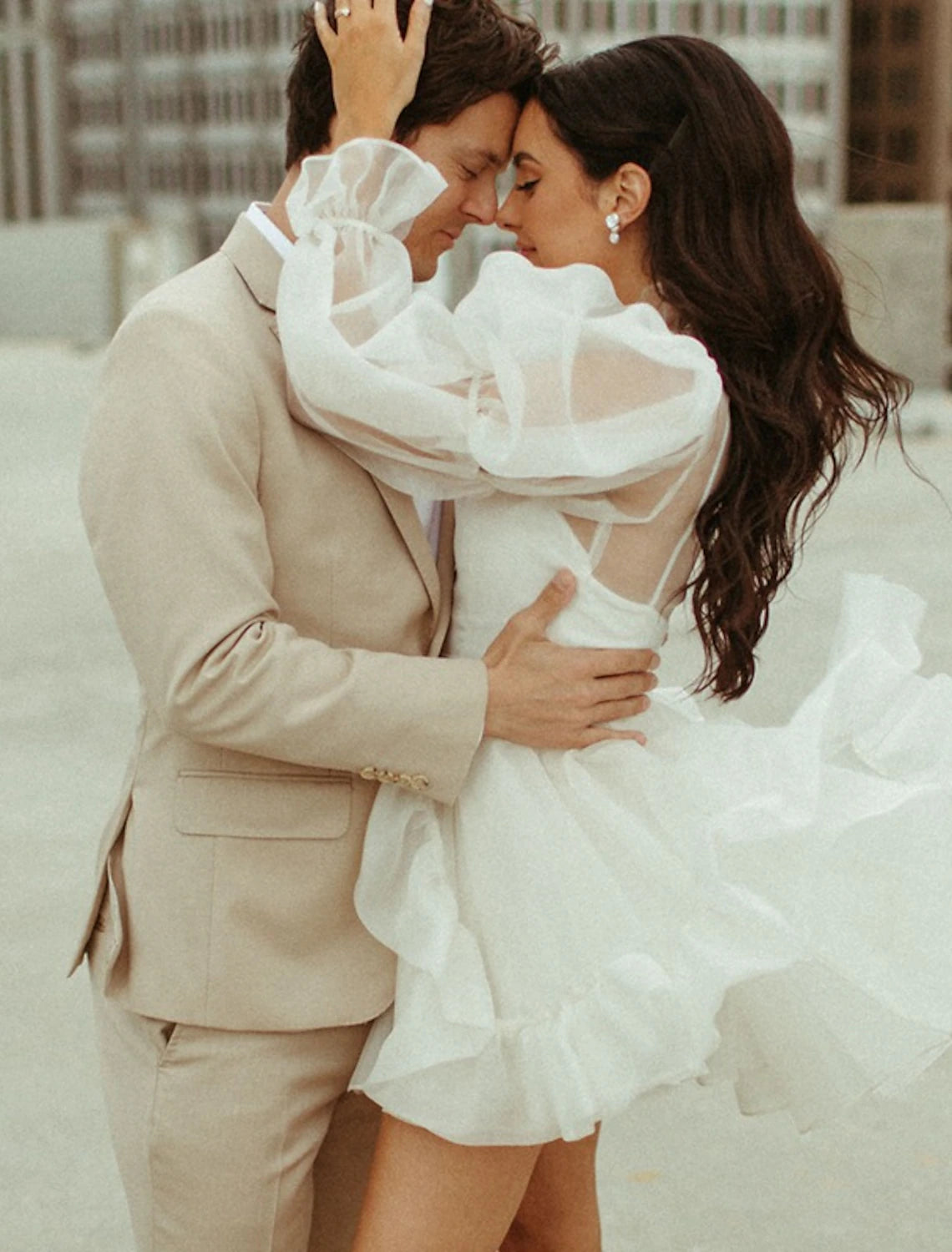 Back view of the A-line high neck long sleeve organza mini wedding reception dress.