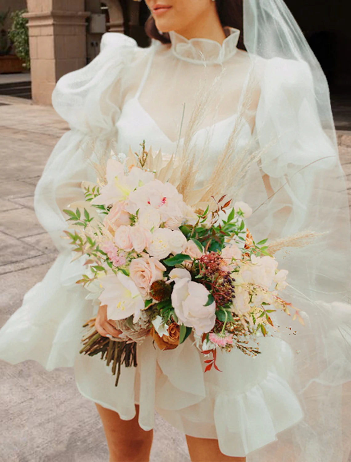 Close-up of the organza fabric and high neck detail of the wedding reception dress.