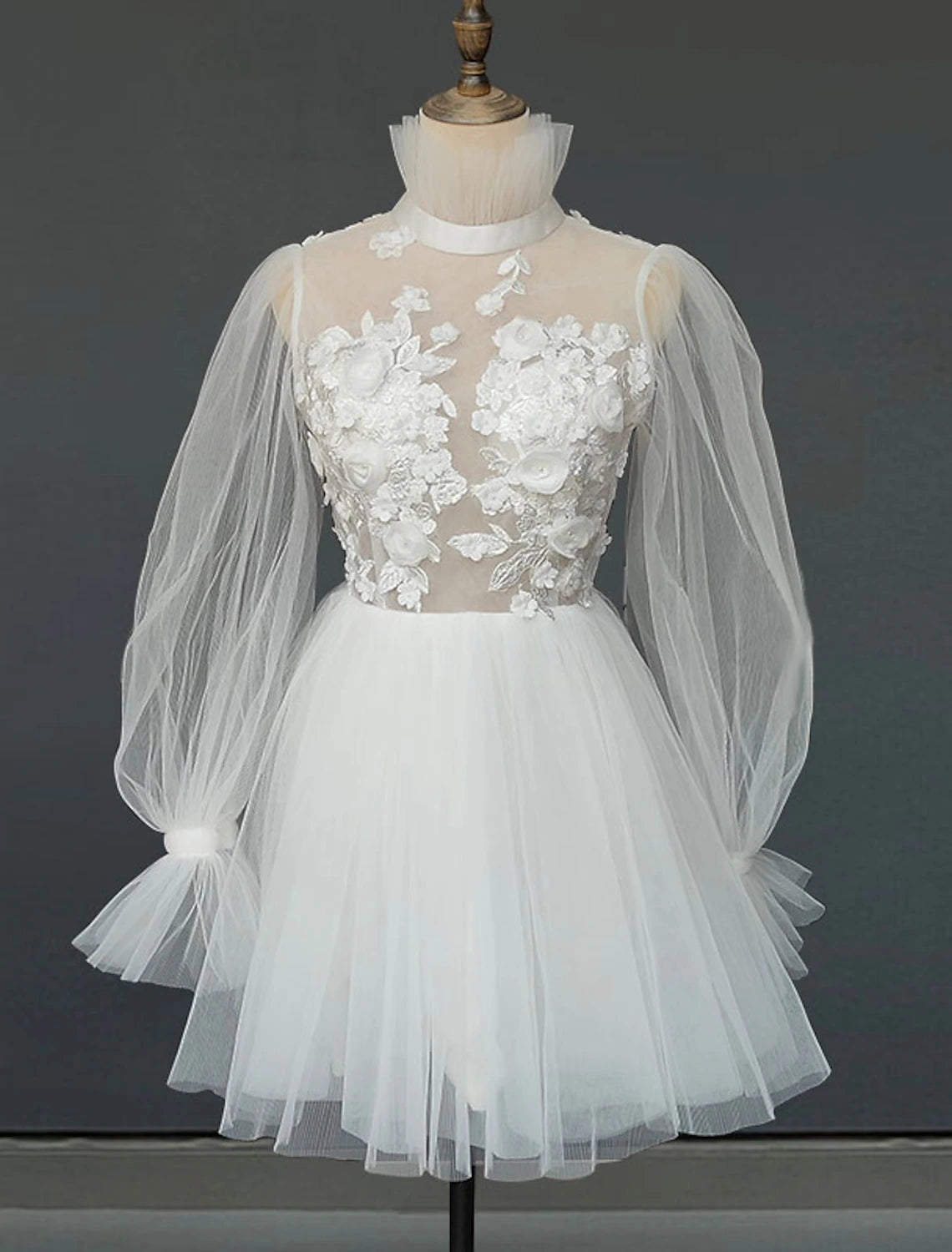 White A-line mini wedding dress with high neck and long sleeves.
