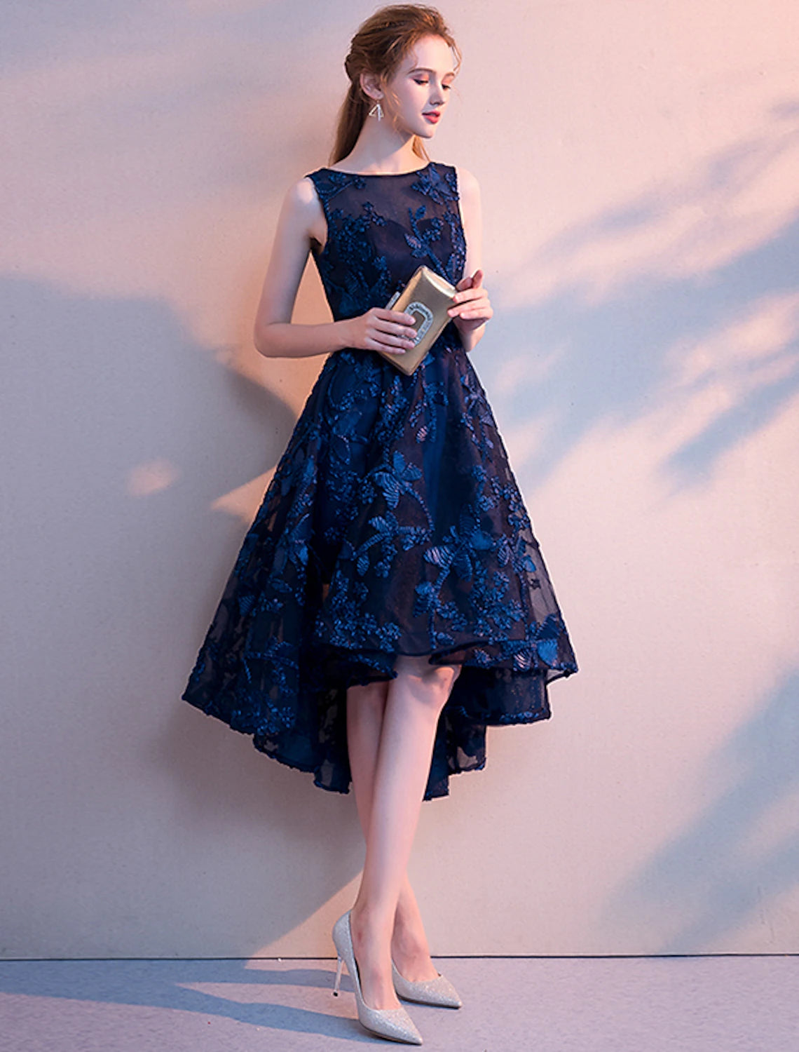 Back view of teal A-line dress showing asymmetrical hem.
