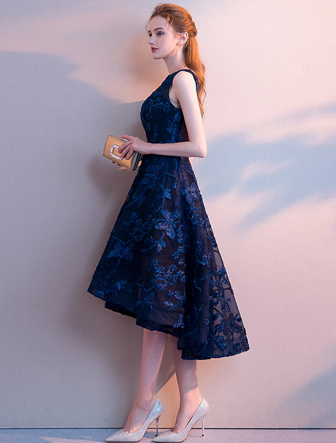 Model posing in teal A-line dress, showcasing flowy tulle fabric.