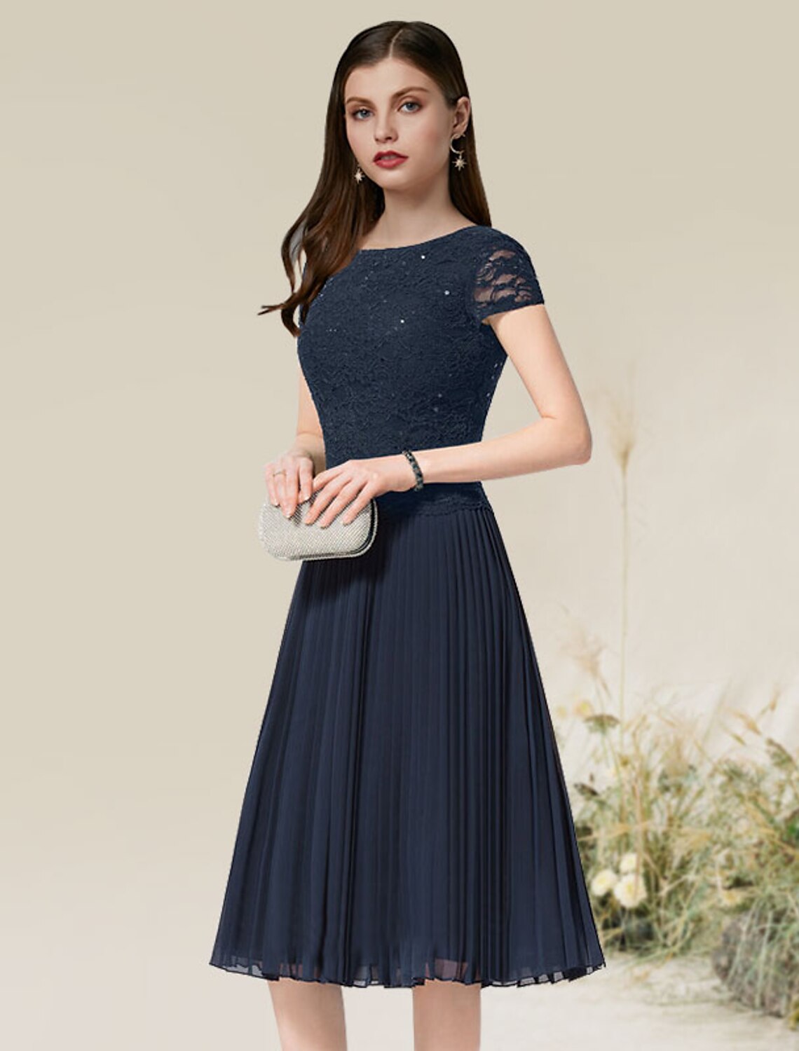 Side view of a woman showcasing the flowy chiffon and pleats of the A-line dress.