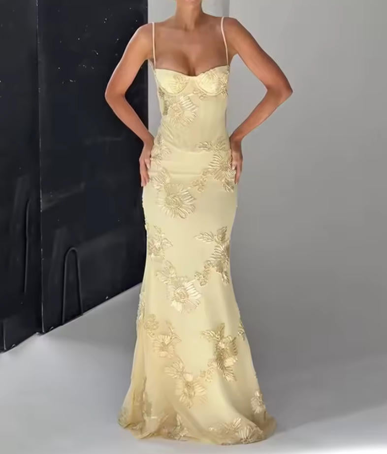 Woman wearing a chic A-line off-shoulder floral maxi gown.