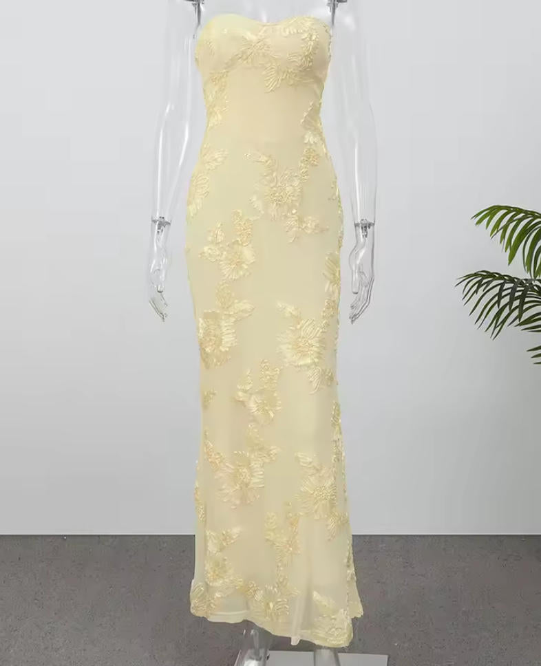 Woman posing in the chic A-line off-shoulder floral maxi gown.
