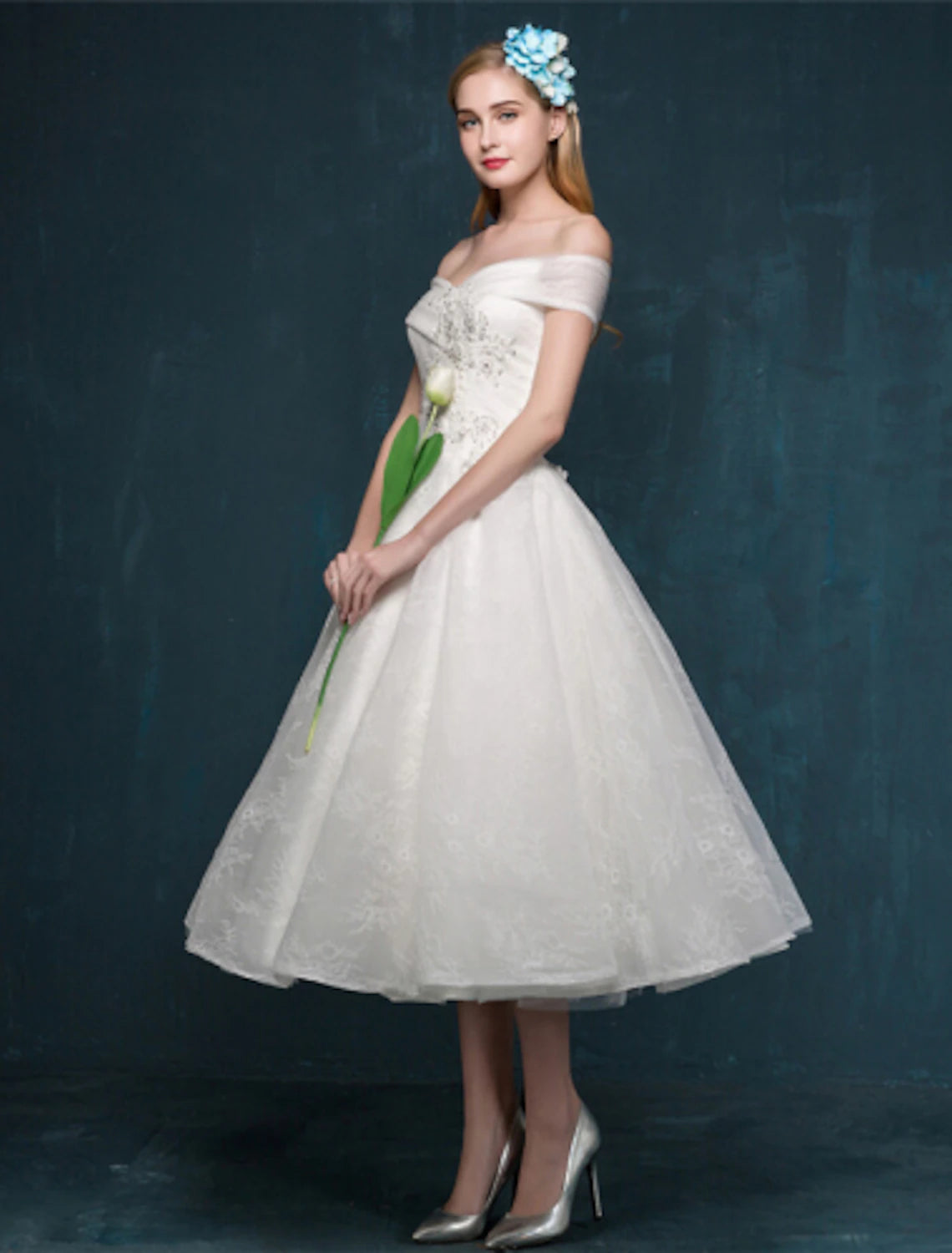 Back view of the white A-Line off-shoulder cap sleeve tea length lace dress.