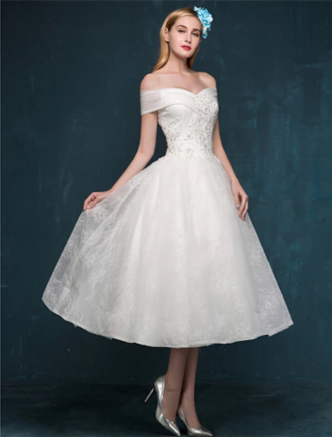 Close-up of the lace, beading, and sequin details on the white reception dress.
