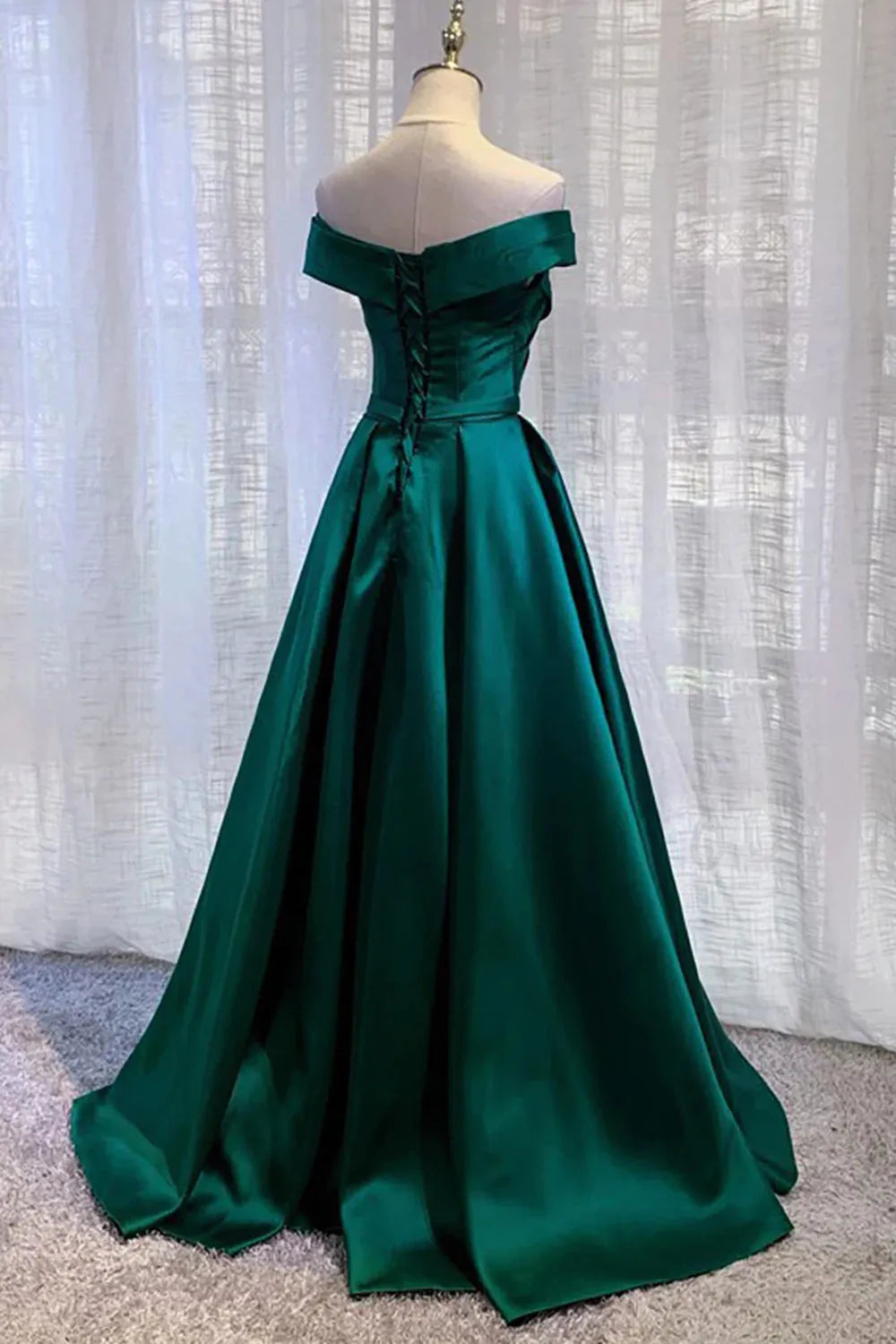 Back view of an A-line off-shoulder long prom dress on a model.