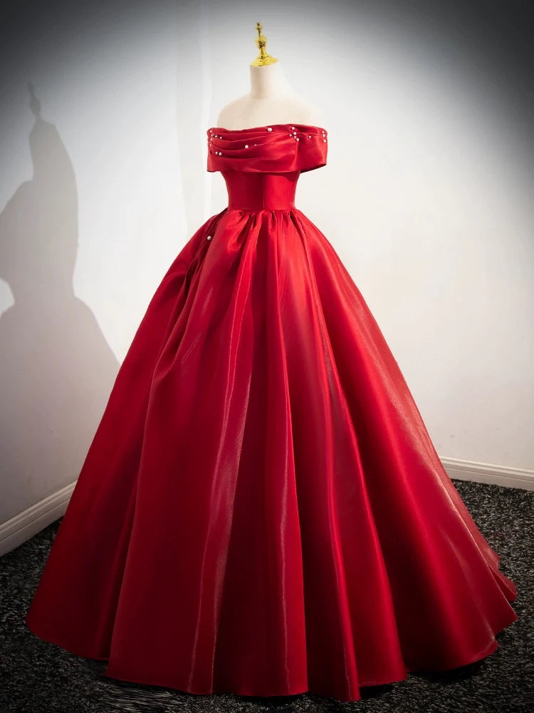 Close-up of the satin fabric and off-shoulder detail of the long prom dress.