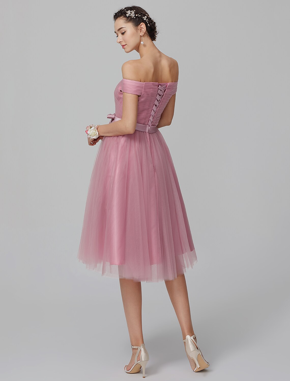 Side profile of the knee-length tulle bridesmaid dress.