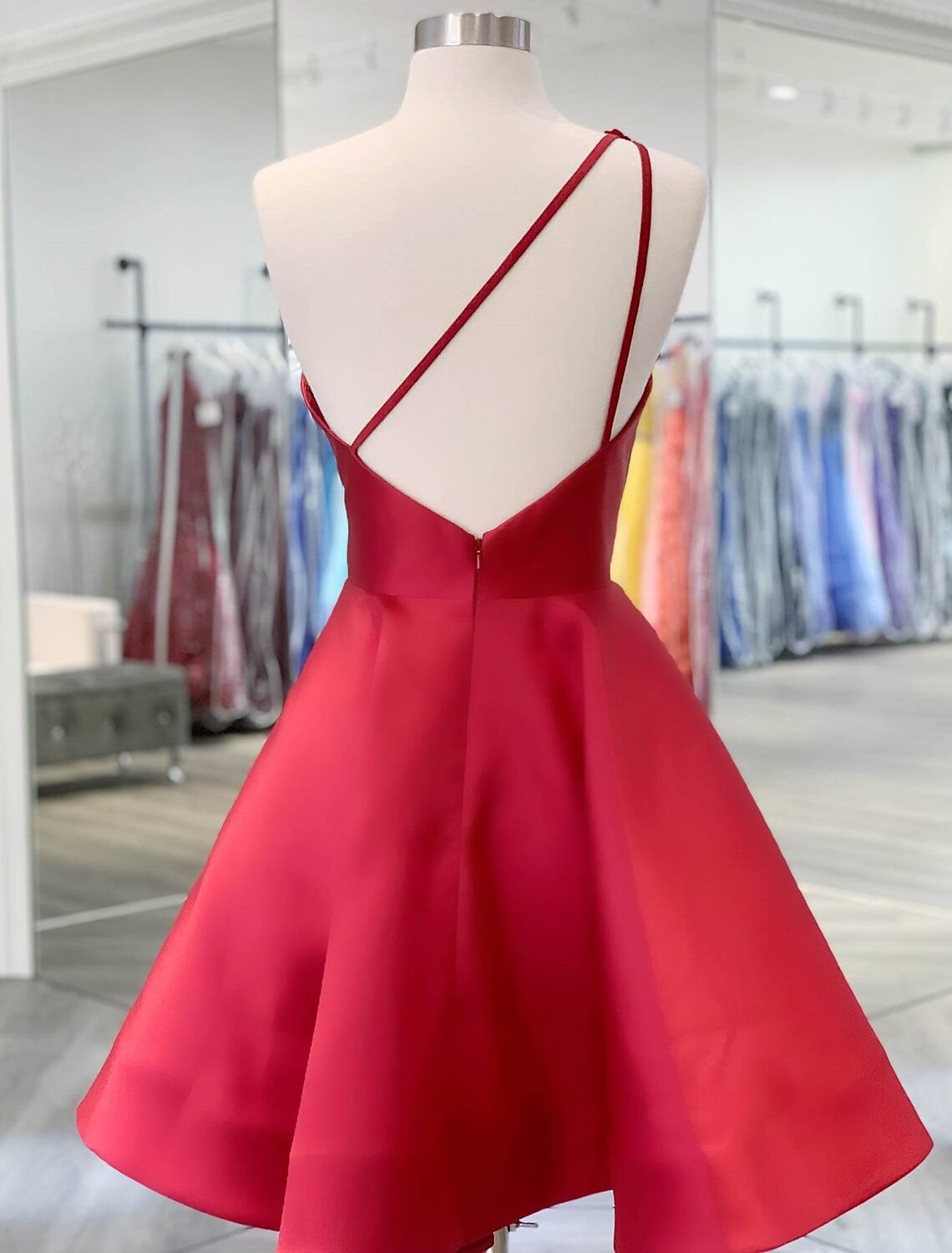 Close-up of the appliques on the A-line one-shoulder satin homecoming dress.