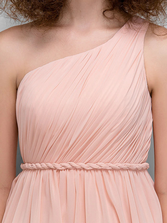 Model wearing a knee-length one-shoulder formal dress.