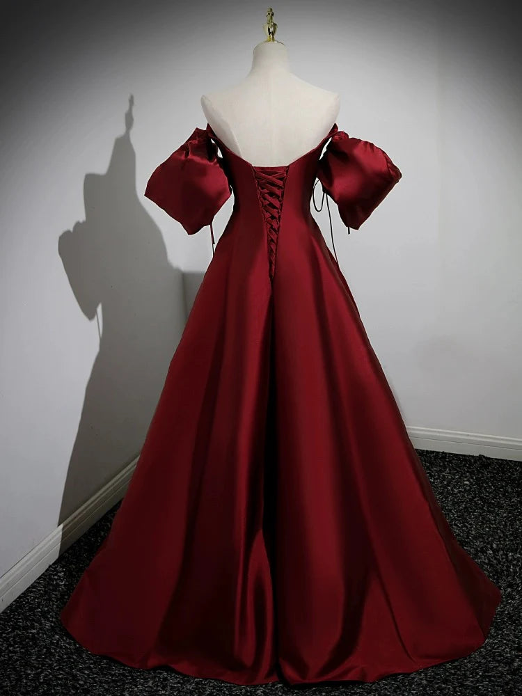 Side view of the elegant satin A-line gown with puff sleeves.