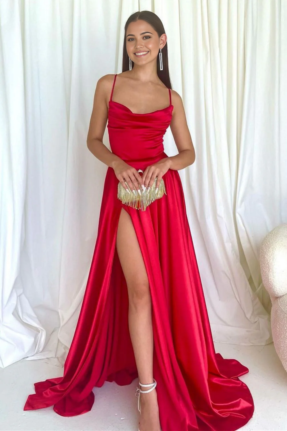 Front view of a model wearing a red A-line long prom dress with spaghetti straps and a V-neck.
