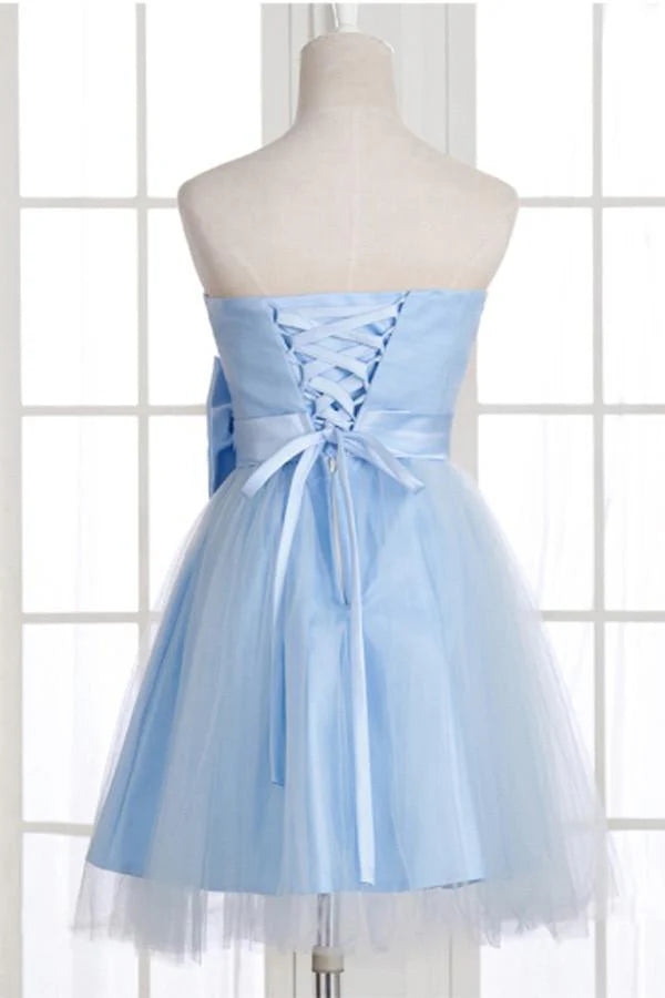 Back view of an A-line strapless short prom dress featuring a prominent bowknot.