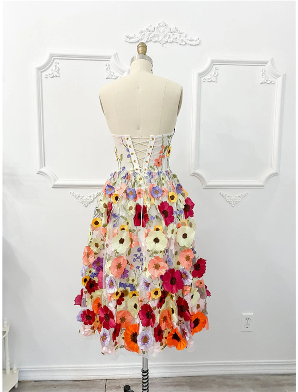 Back view of a-line strapless floral dress.