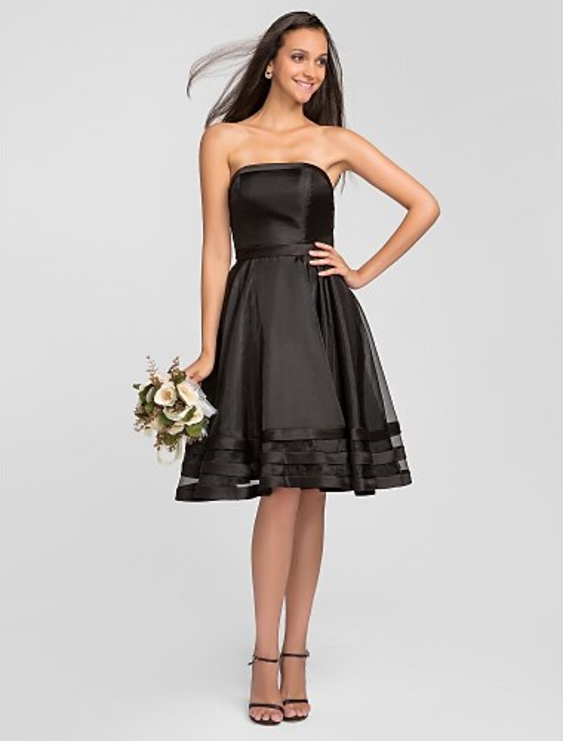 A-Line strapless organza bridesmaid dress with pleats and ruffles.
