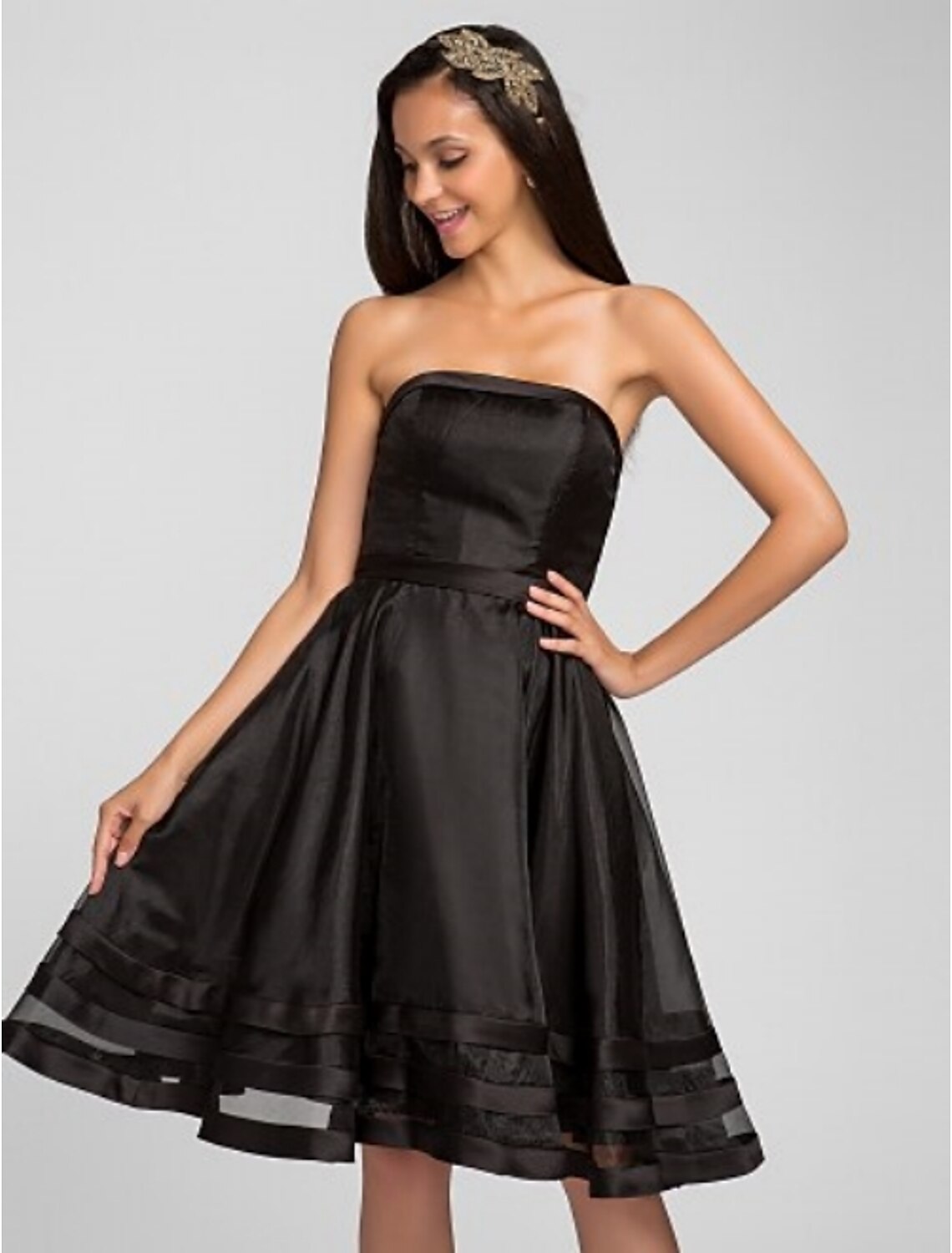 Back view of a knee-length organza bridesmaid dress.