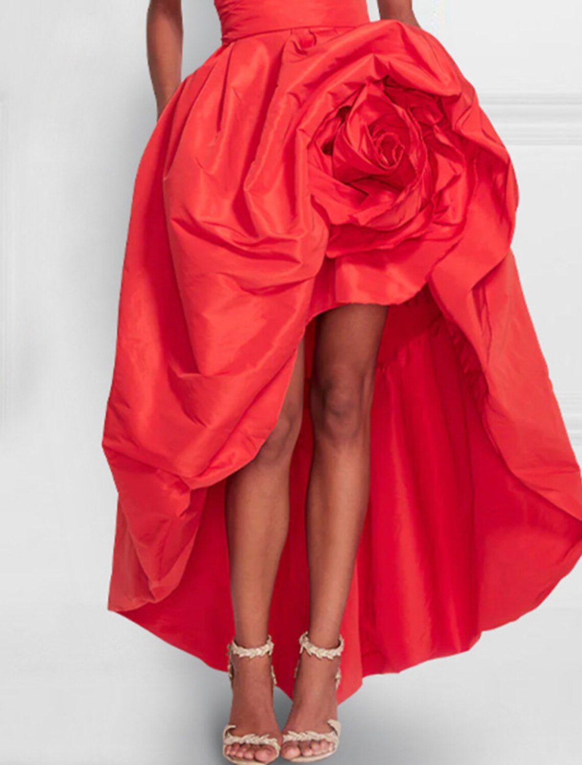 Chic red cocktail dress with an asymmetrical skirt and strapless design.