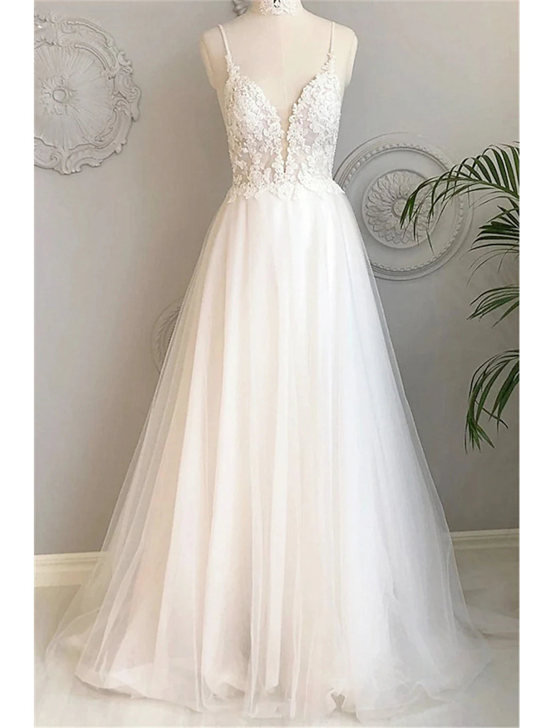 A-Line sweetheart spaghetti strap lace beach wedding dress with appliques and buttons.