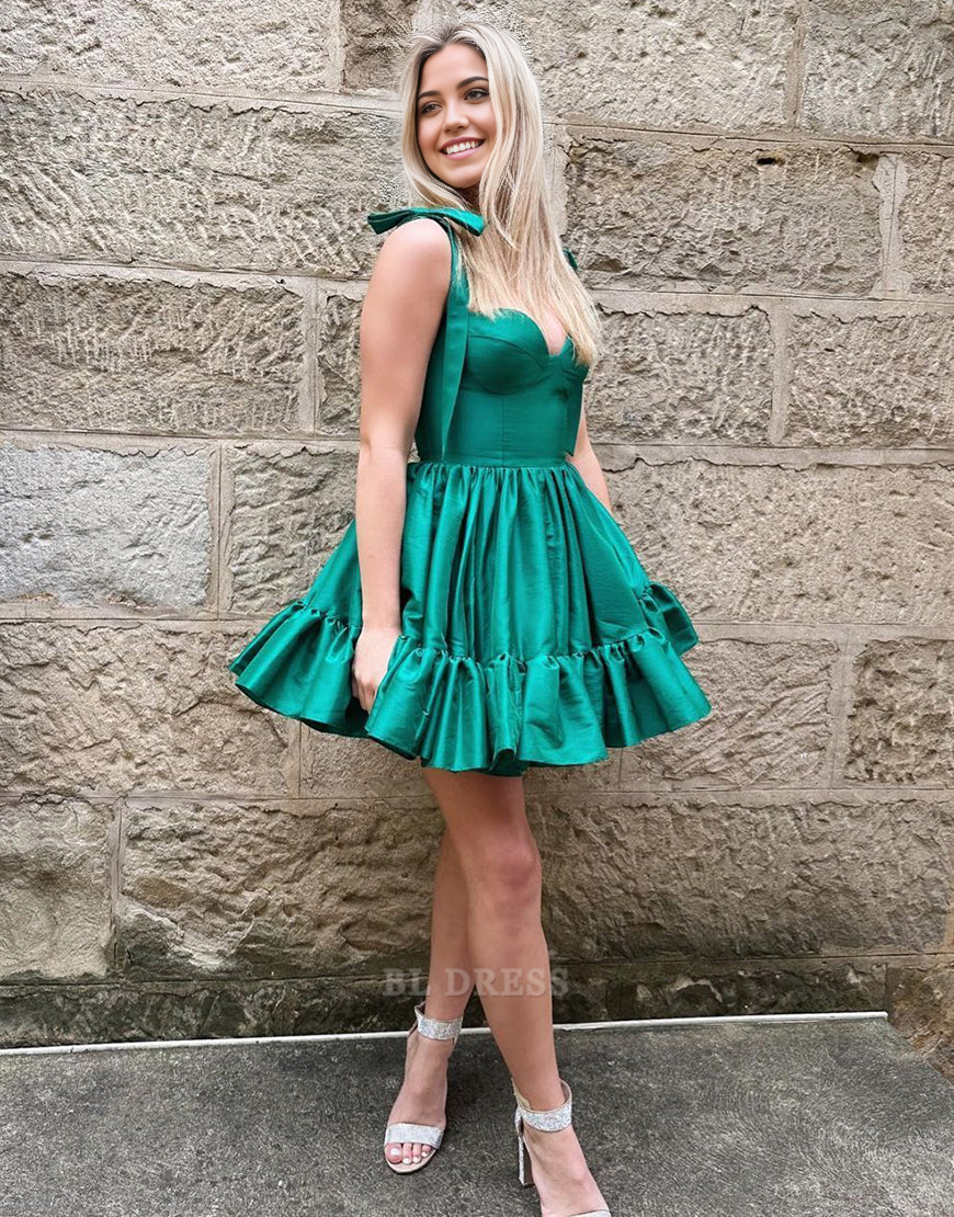 Model wearing a green A-line sweetheart tie-strap short satin dress.