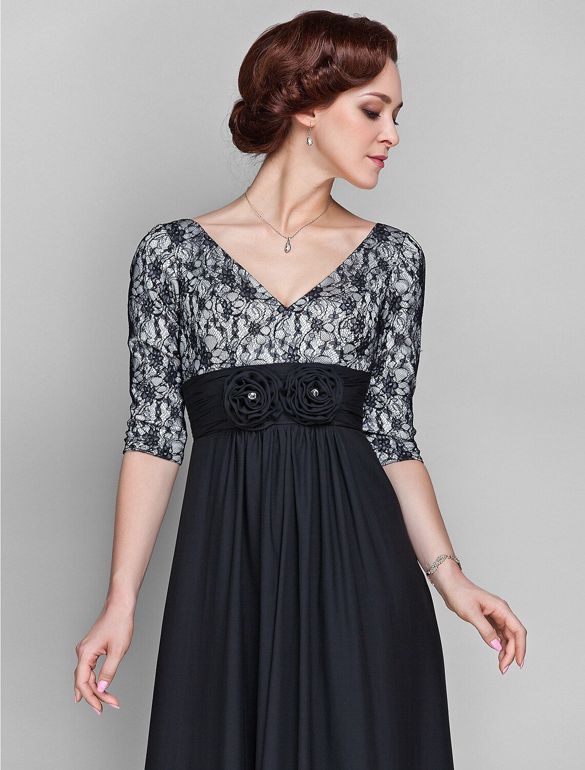 Detail of the ruched flower embellishment on the elegant chiffon dress.
