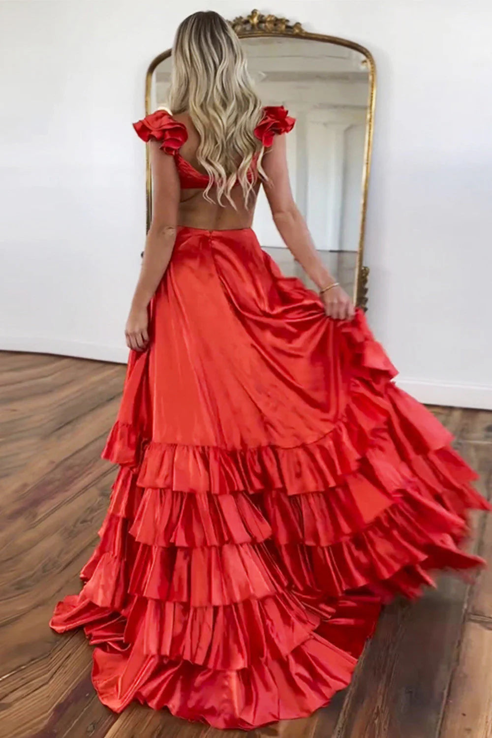 Side view of the tiered red satin prom dress with a high split.