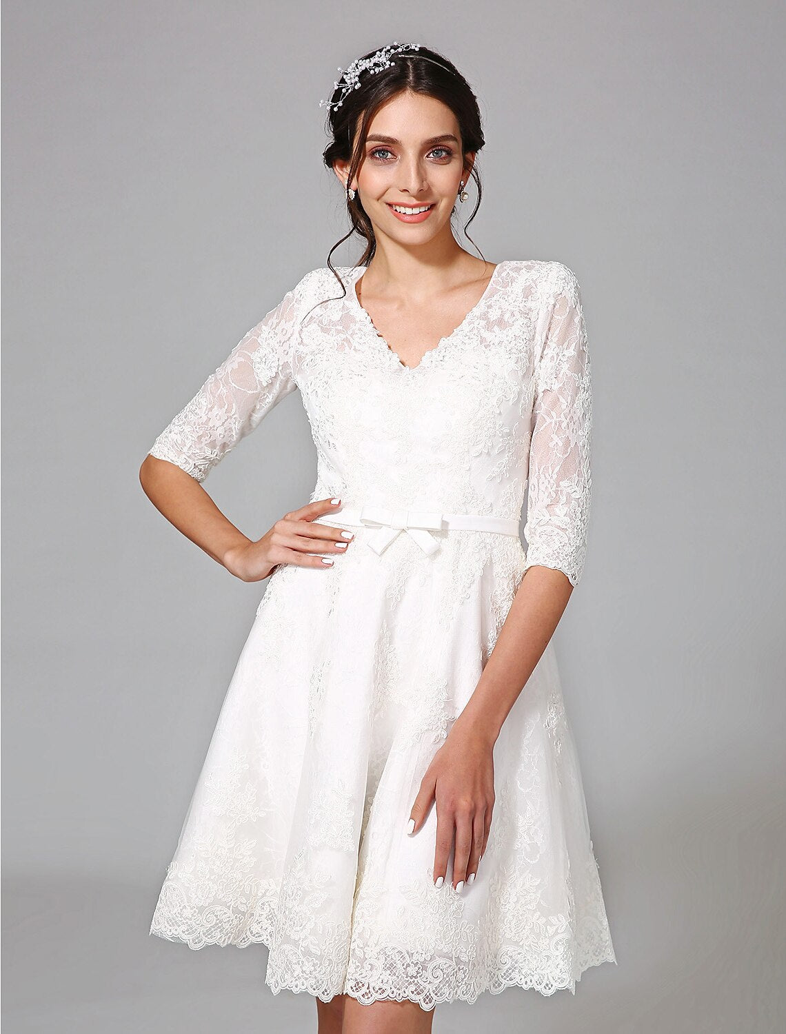 White A-line lace dress with V-neck and half sleeves.