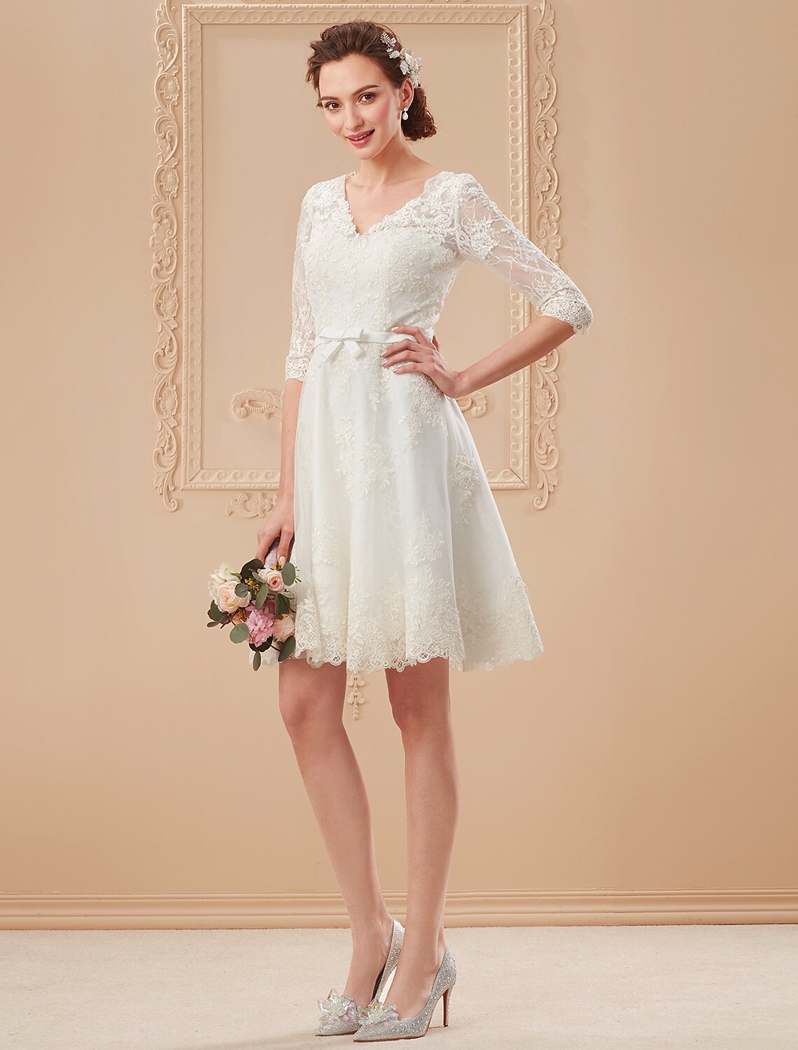White A-line reception dress with elegant bow detail.