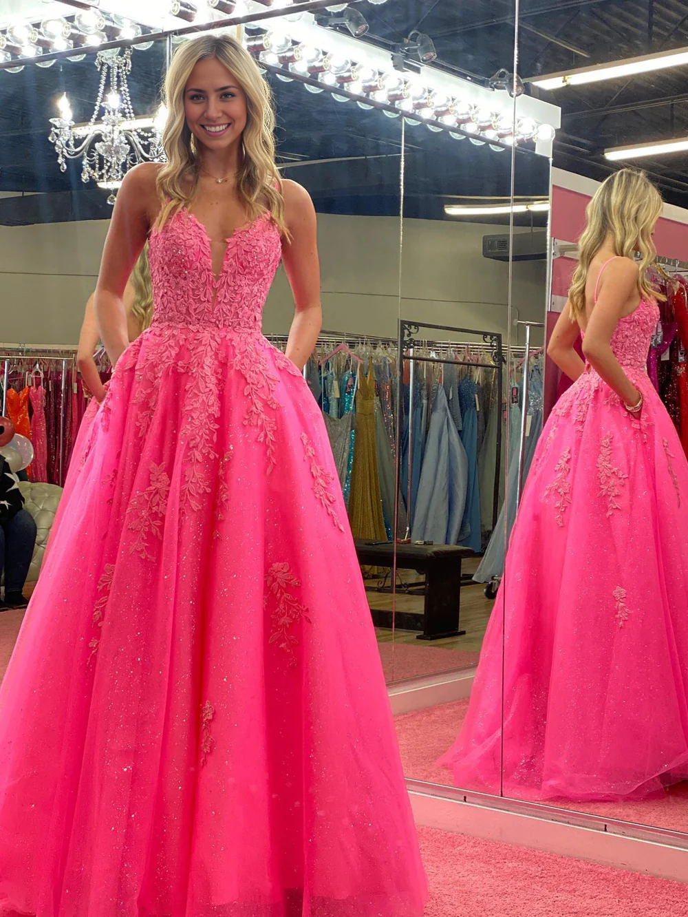 Woman posing in an elegant A-line V-neck lace long prom dress.