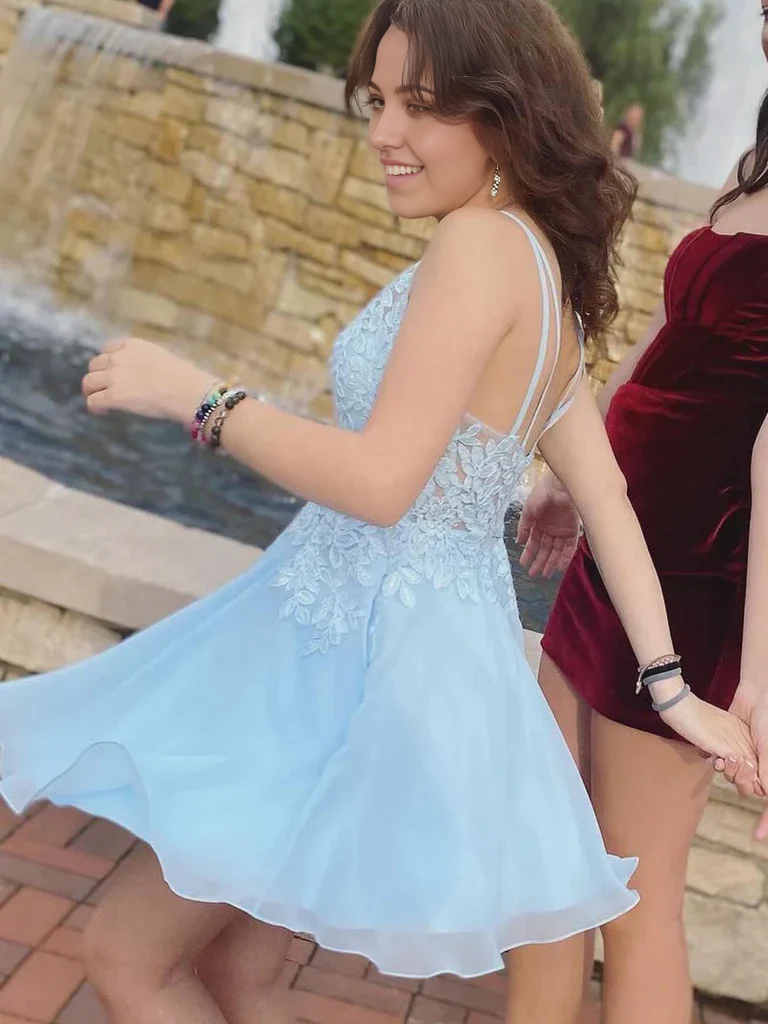 Back view of a woman in a short lace homecoming dress.