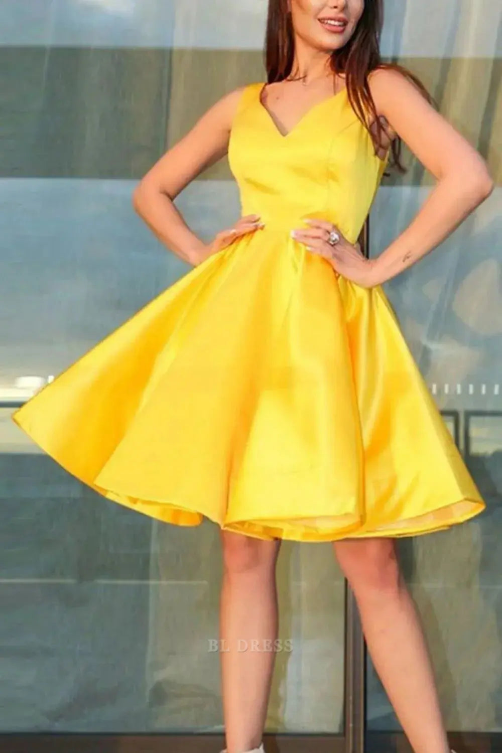 Woman wearing a lemon A-line V-neck knee-length dress.