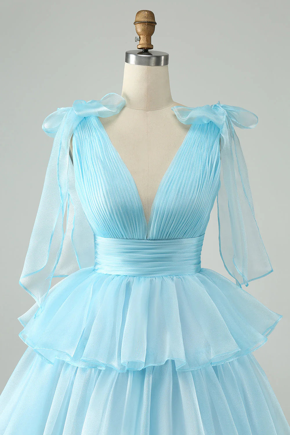 Close-up of pleated and tiered details on the short homecoming dress.