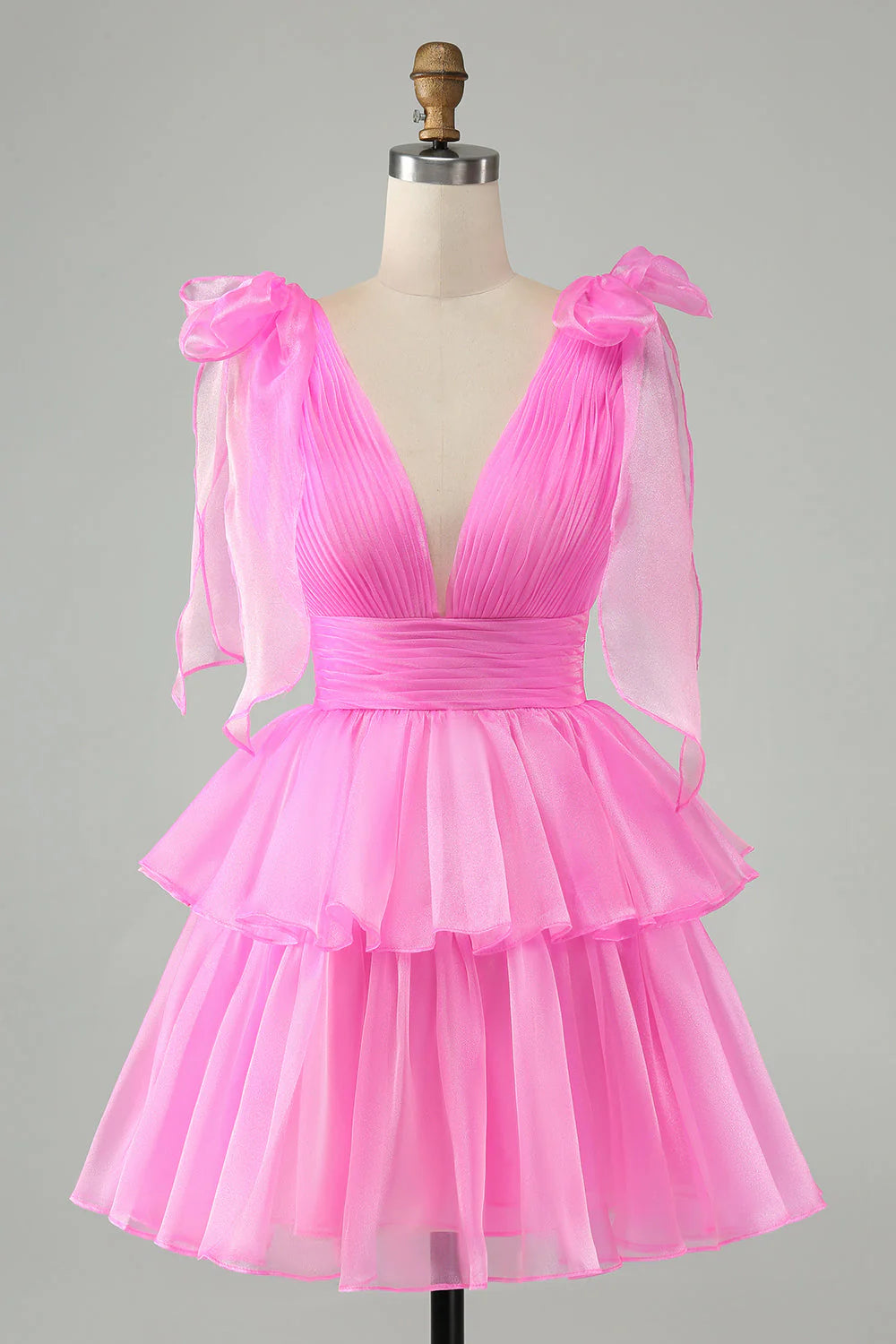 Model wearing A-line V-neck pleated tiered short homecoming dress, posing.