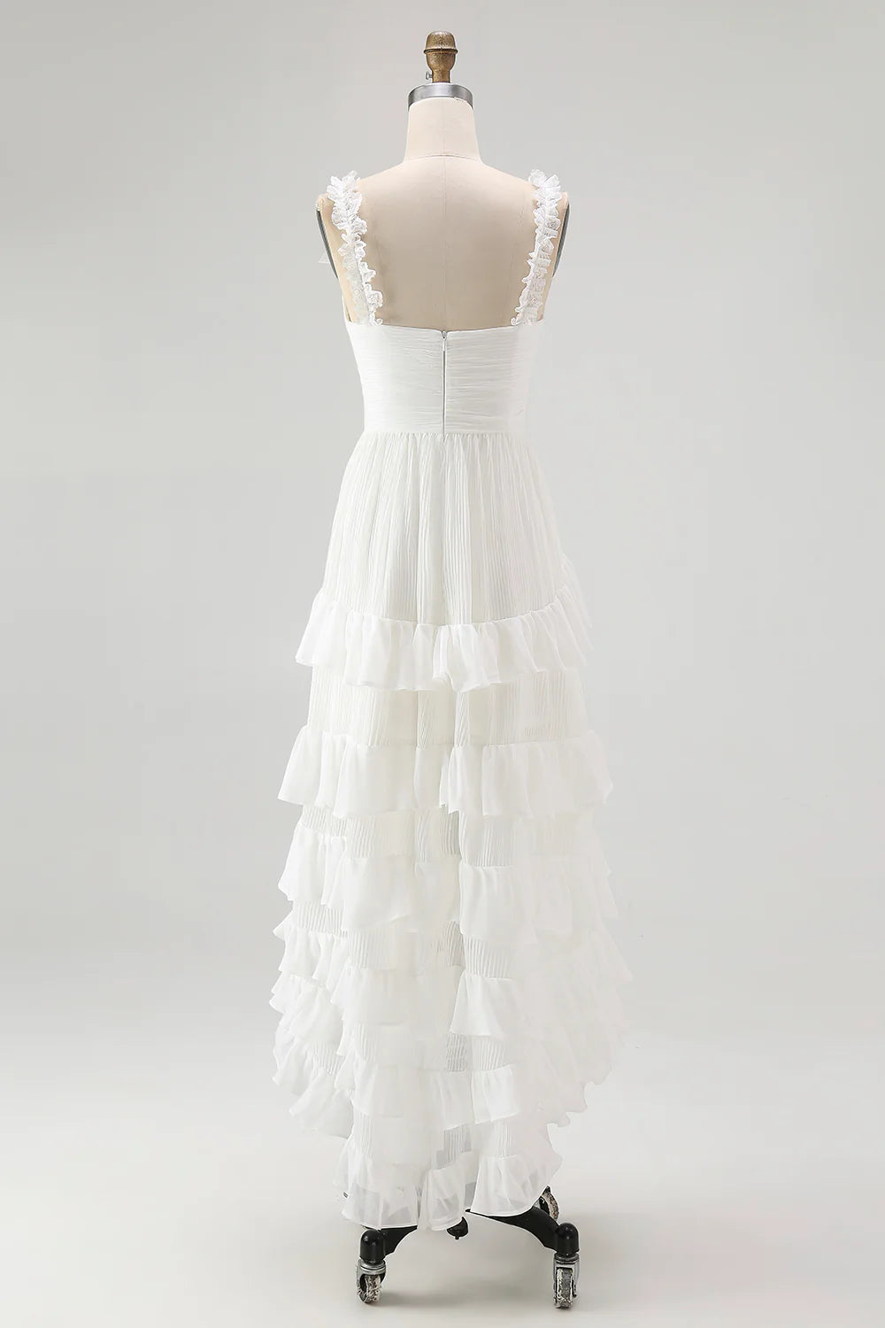 Close-up of the V-neckline and ruffled details on the Ivory wedding dress.