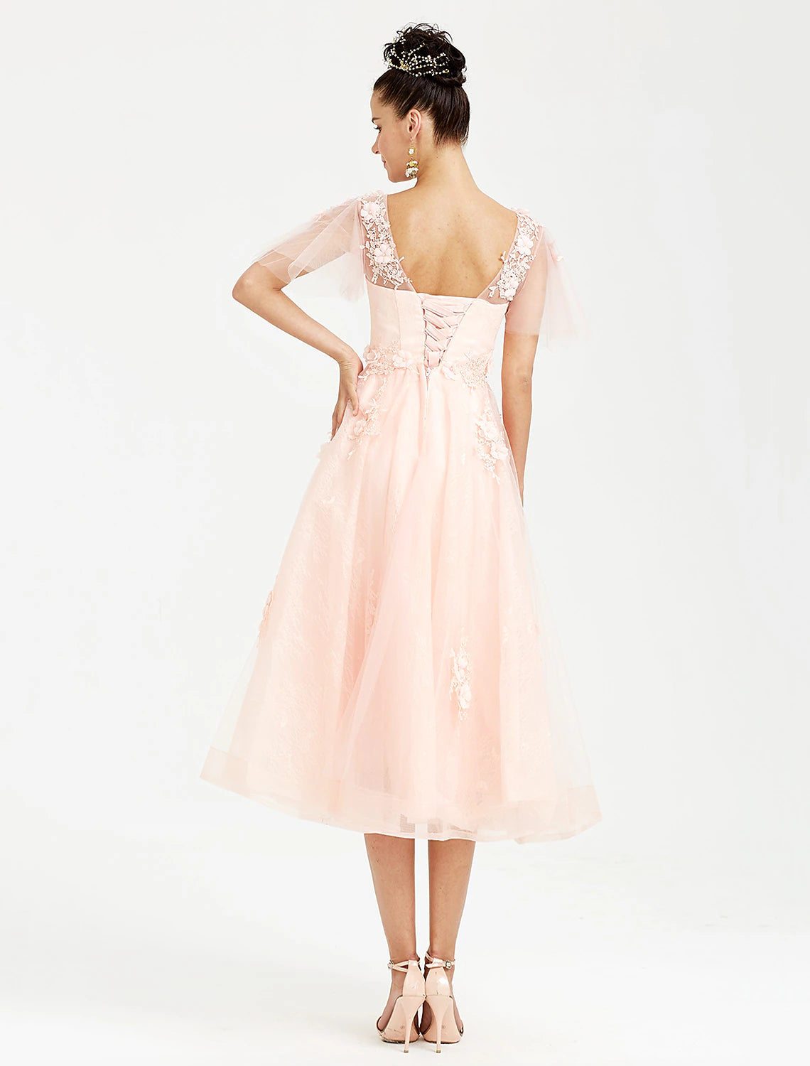 Back view of the tea length formal dress with short sleeves.