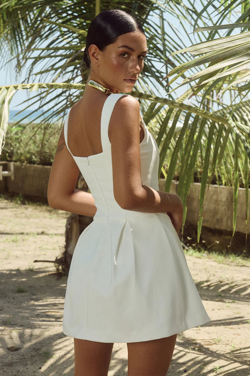 Back view of a woman in a backless A-line homecoming dress.