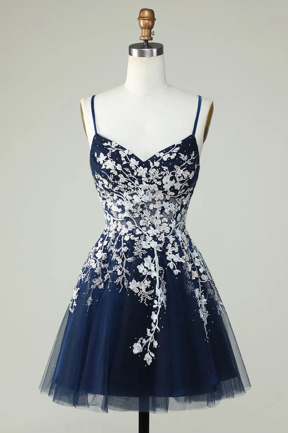 Back view of the short A-line V-neck homecoming dress featuring a criss-cross strap design.
