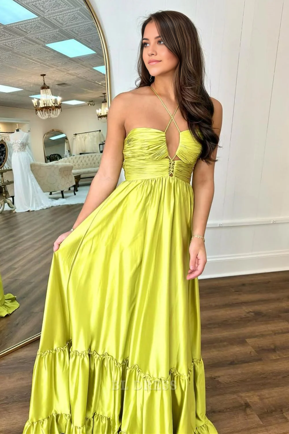 Yellow A-line satin prom dress with spaghetti straps and lace-up back.