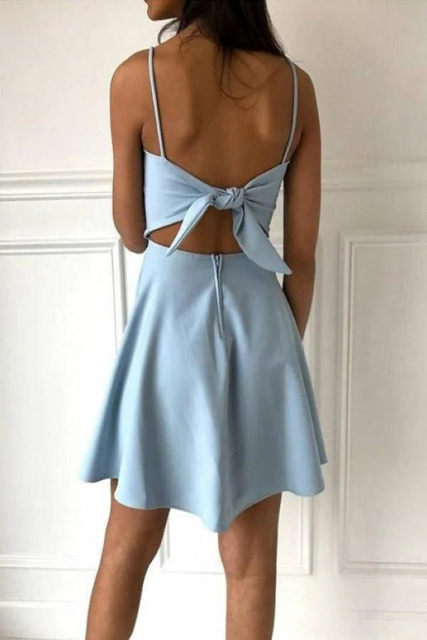 Model wearing a light blue A-line satin homecoming dress with spaghetti straps.