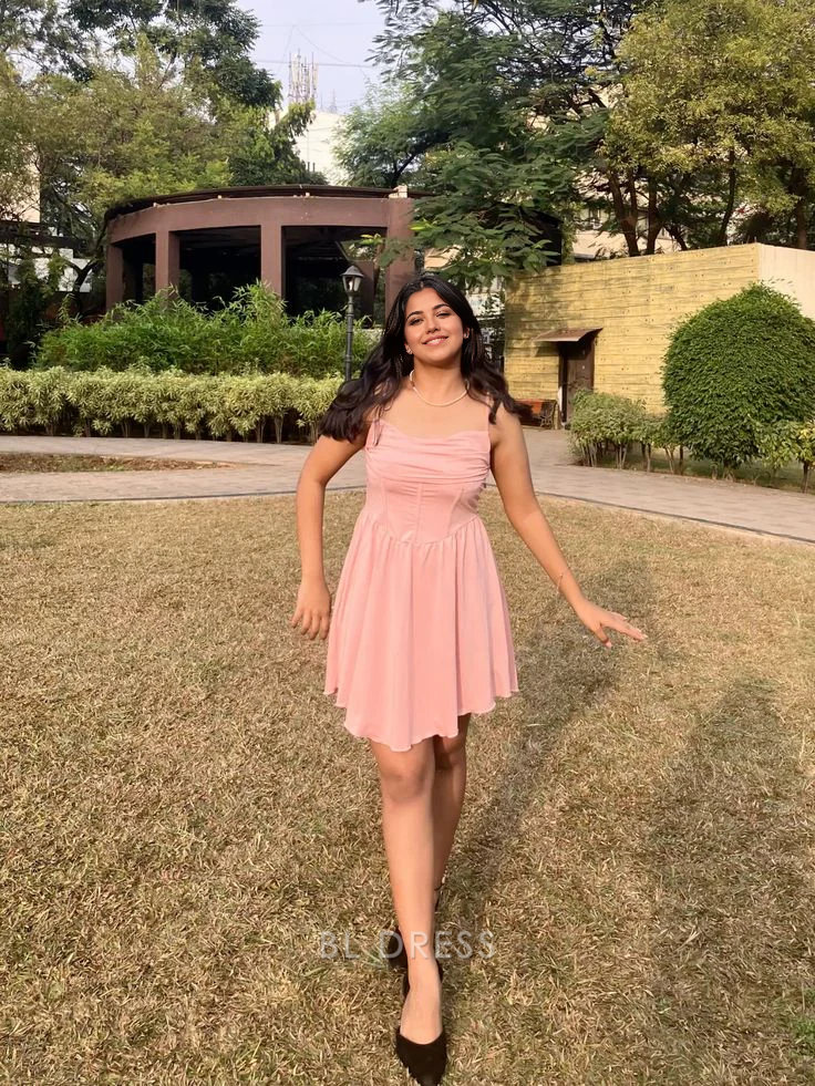 Pink A-line short formal dress with spaghetti straps and V-neck.