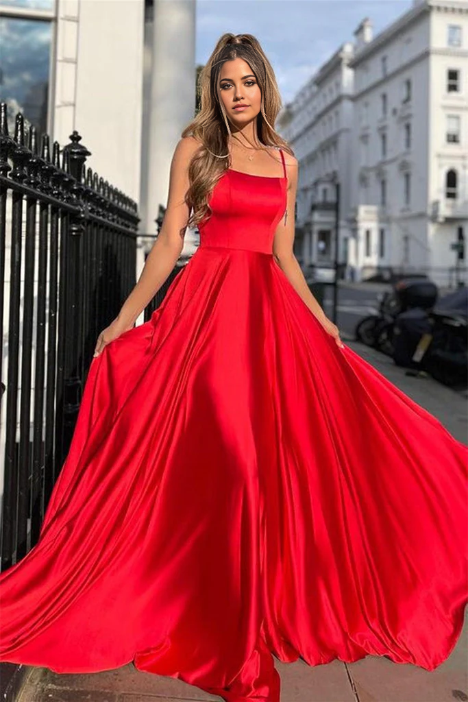 Model wearing a light blue A-line satin long prom dress with scoop neck and spaghetti straps.