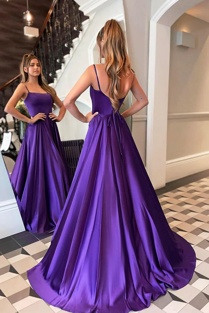 Model walking in the flowing light blue scoop neck satin gown.