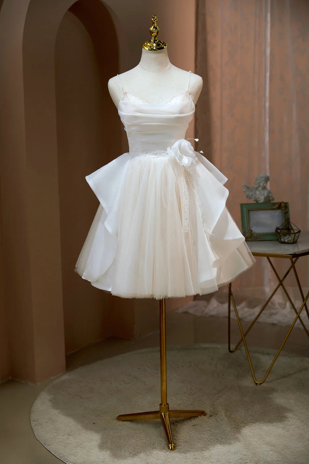 Light blue A-line homecoming dress with spaghetti straps and intricate beading.