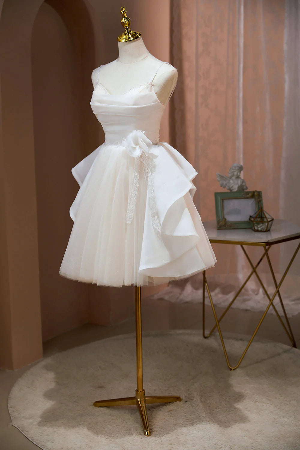 Side profile of a short light blue beaded A-line dress.