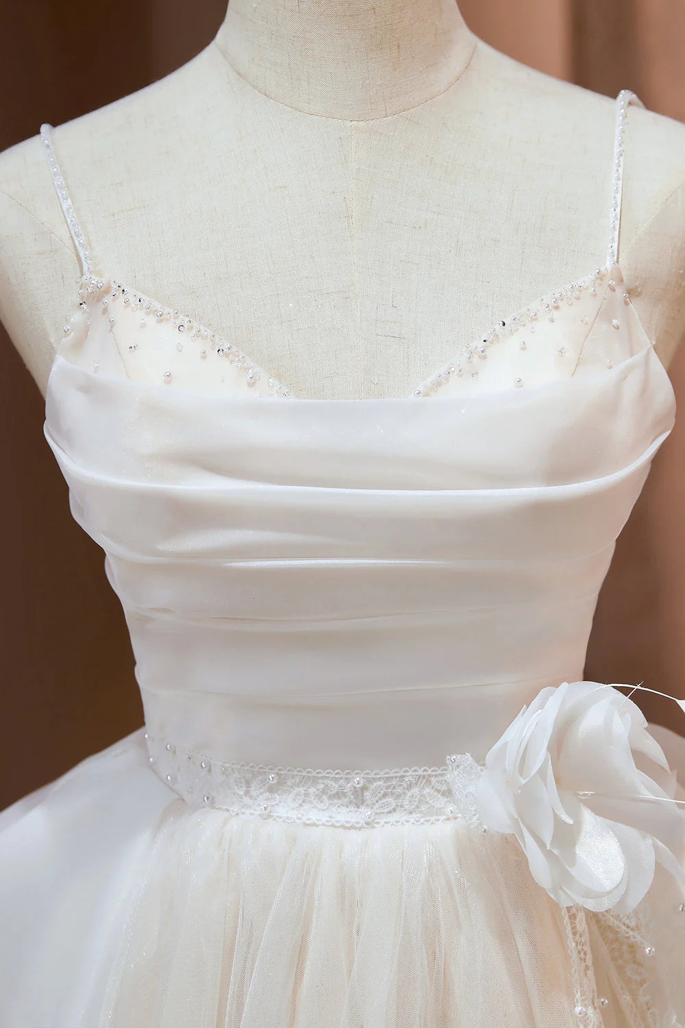 Close-up of the beaded bodice on a light blue spaghetti strap dress.
