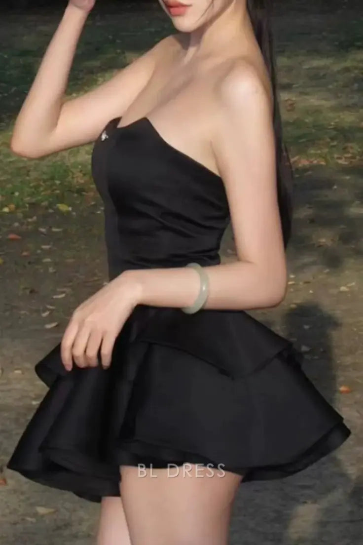 Back view of the black satin A-line strapless short layered dress.