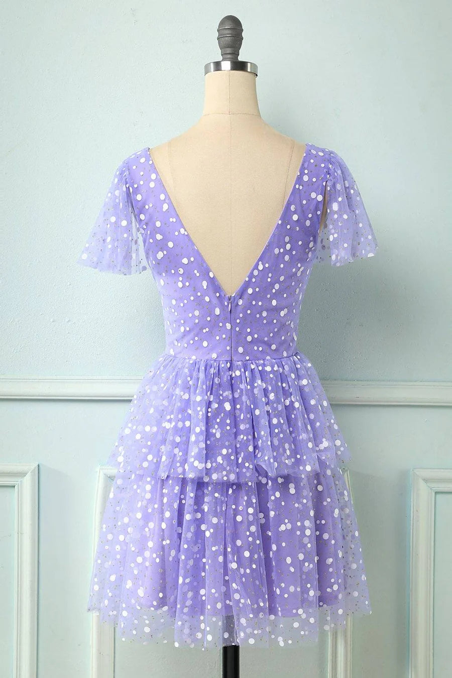 Side view of the A-line V-neck dotted mini dress, showing multi-layers.