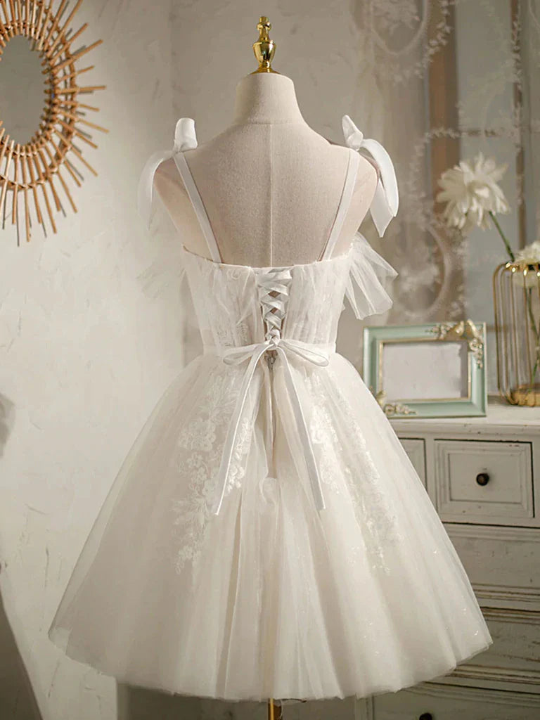 Side view of a model wearing a light-colored A-line V-neck lace mini homecoming dress.