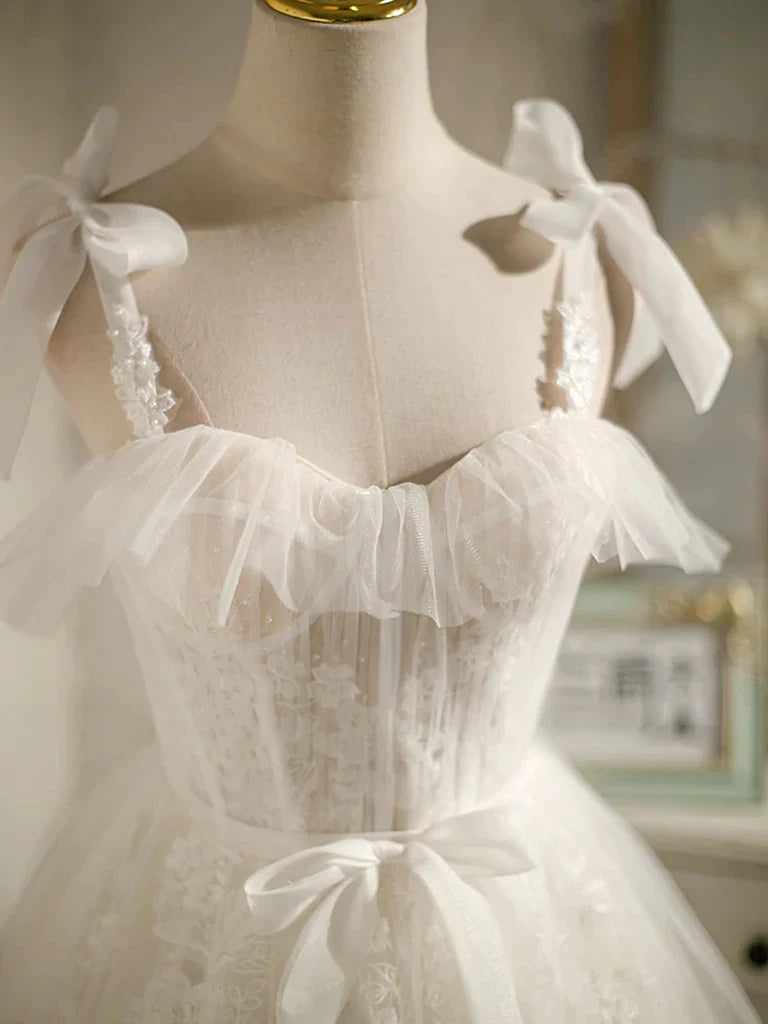 Back view of a model wearing a light-colored A-line V-neck lace mini homecoming dress.